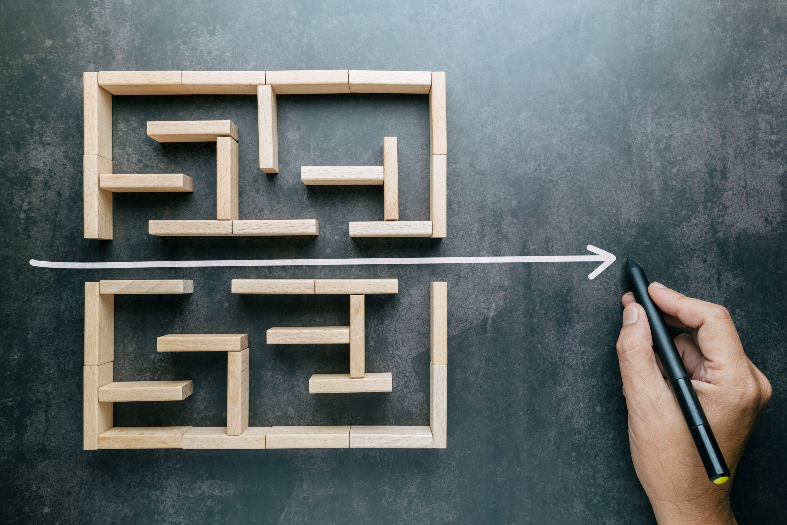 A hand that draws a straight line through a maze game with the shortest possible line, shorten the process, and simplify concept